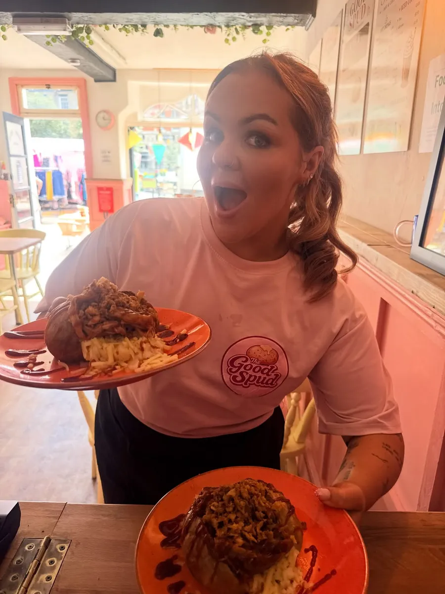 Evie Capps founder of The Good Spud proudly serving her famous BBQ pulled pork jacket potatoes